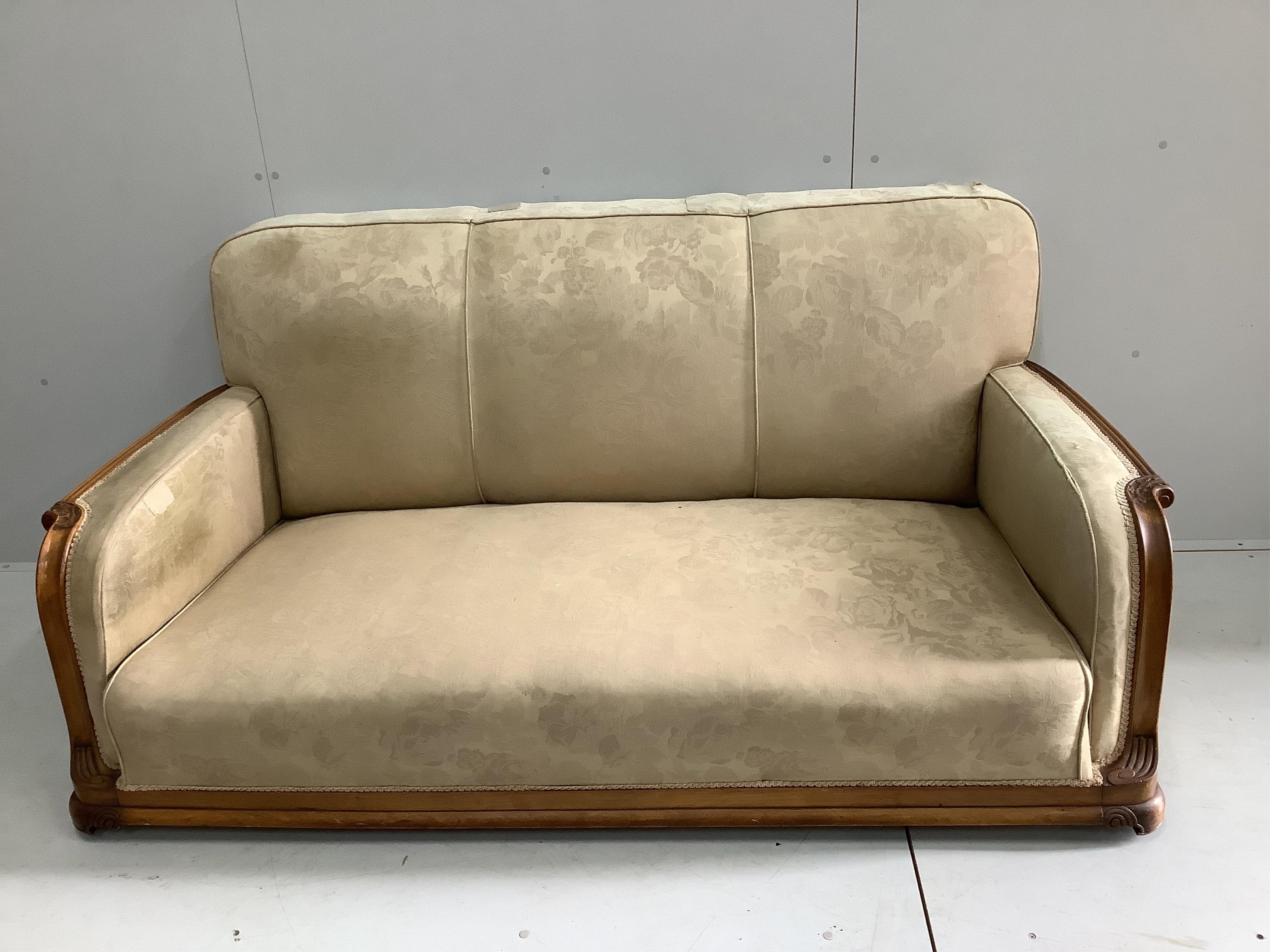 An Art Deco upholstered carved beech three piece suite, settee width 180cm, depth 80cm, height 82cm. Condition - fair, upholstery poor